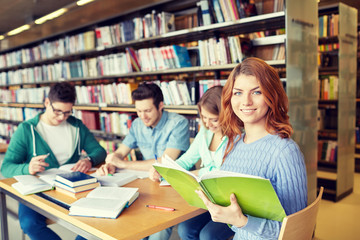 students with books preparing to exam in library
