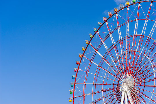 Ferris wheel against blue sky background