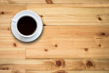 White coffee cup on wooden table top view