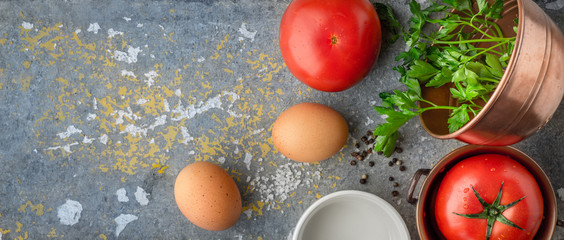 Ingredients for baked eggs with tomatoes  on the stone table wide screen