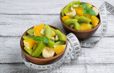 Fruit salad with kiwi, banana and orange for slimming and centim
