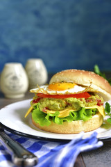 Vegetarian burger with guacamole and roasted egg.