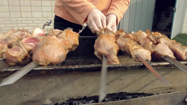 Barbeque skewers with meat cooking on hot coal ember brazier Outdoors picnic concept. 4K UHD video footage.
