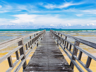 Jetty at beach with blue sky