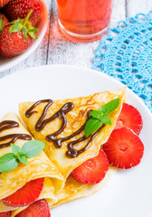 Pancakes with sliced strawberries and chocolate