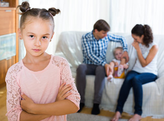Fototapeta premium girl sad because of jealous younger sister to parents