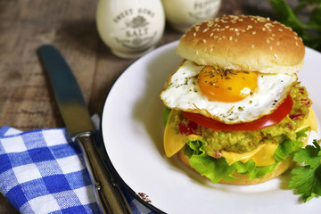 Vegetarian burger with guacamole and roasted egg.