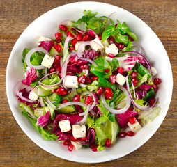 Healthy salad with feta cheese and pomegranate.