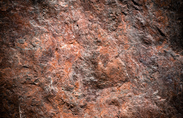 Stone background, rock wall backdrop with rough texture. Abstract, grungy and textured surface of stone material. Nature detail of rocks.