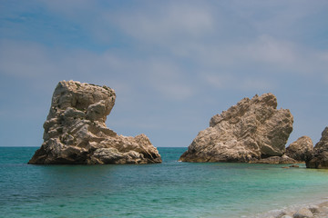 Fototapeta na wymiar Rock and sea. Photo of two sisters beach (Spiaggia delle due Sorelle), Monte Conero in the adriatic sea.
