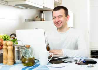 Successful man with laptop at table
