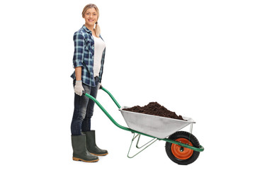 Woman posing with wheelbarrow full of dirt
