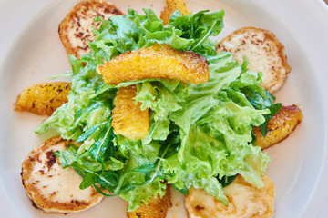 Salad with arugula, fried cheese and orange slices