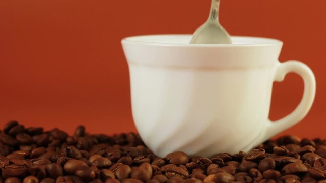 Man spoon prevents coffee on a brown background