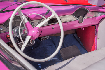 Inside of a vintage pink classic american car in Cuba