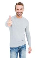 Young man smiling and giving a thumbs up