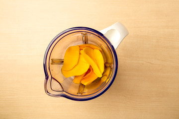 Fresh mango and blender, clean food, view from above