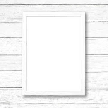 White blank picture frame on white wood wall.