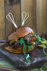 BBQ pulled beef in a brioche bun with rocket lettuce