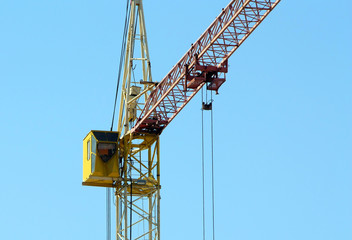 Fototapeta na wymiar Cranes building against the blue sky. Heavy construction equipment. 