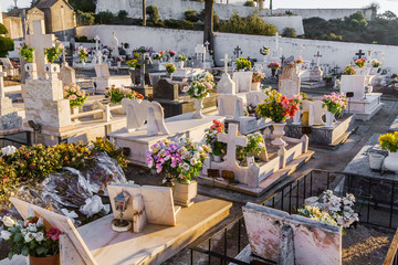 Typical Catholic cemetery with the graves decorated with flowers in the interior south of Portugal.