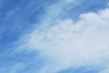 blue sky with abstract feathery clouds
