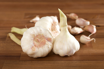 garlic bulb and clove on wooden background