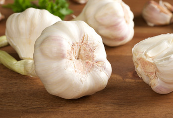 garlic bulb and clove on wooden background