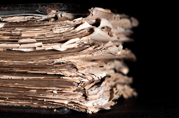 old thick book on a black background on the desktop