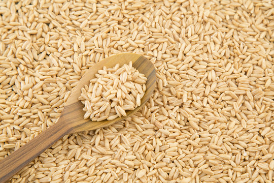 Oat grains and wooden spoon