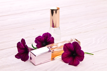 Perfume bottles surrounded by flowers