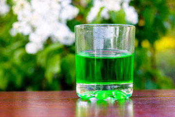 Glass of green absinth