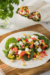 vegan tofu wraps with pepper, corn, tomatoes and spinach