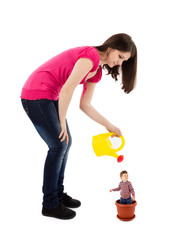 mother watering baby plant