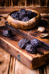 Fresh Dates on vintage wooden background. Selective focus. Toned image