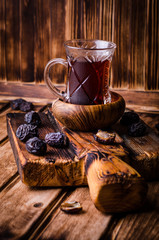 Obraz na płótnie Canvas Dates with tea on vintage wooden background. Selective focus. Toned image