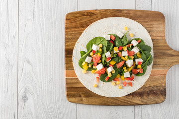 vegan tofu wraps with pepper, corn, tomatoes and spinach