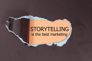 The motivational quote Storytelling is the best Marketing, appearing behind torn paper.
