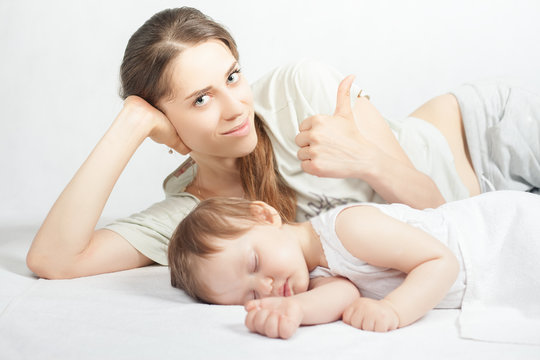 Newborn baby sweet sleeping on a white bed
