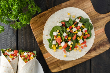 vegan tofu wraps with pepper, corn, tomatoes and spinach