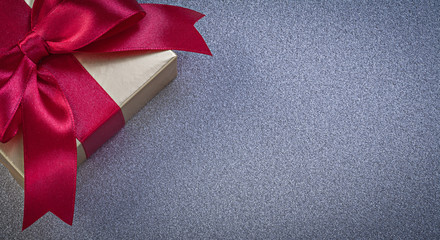 Packed present box with red bow on grey background holidays conc