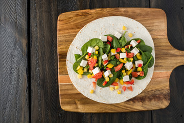 vegan tofu wraps with pepper, corn, tomatoes and spinach