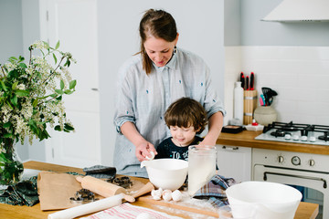 Mother young woman teaching showing her son child how breaking e