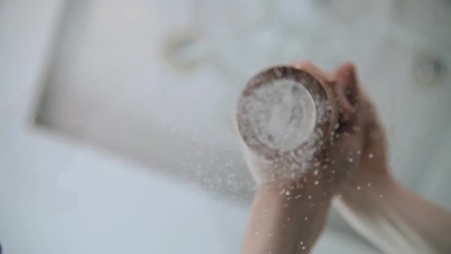 A chef is adding salt and pepper