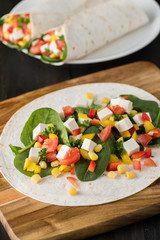 vegan tofu wraps with pepper, corn, tomatoes and spinach