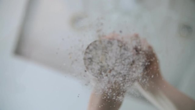 A chef is adding salt and pepper