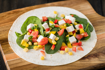 vegan tofu wraps with pepper, corn, tomatoes and spinach