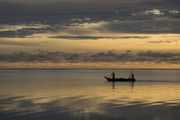 Fishermen going on ocean on traditional fishing boat in Zanzibar