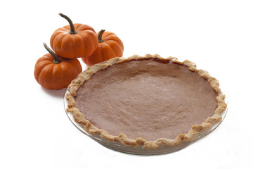 stack of pumpkins with pumpkin pie served over white background.