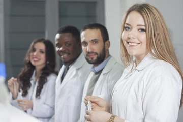 Group of young medical workers are working in lab as lab technic